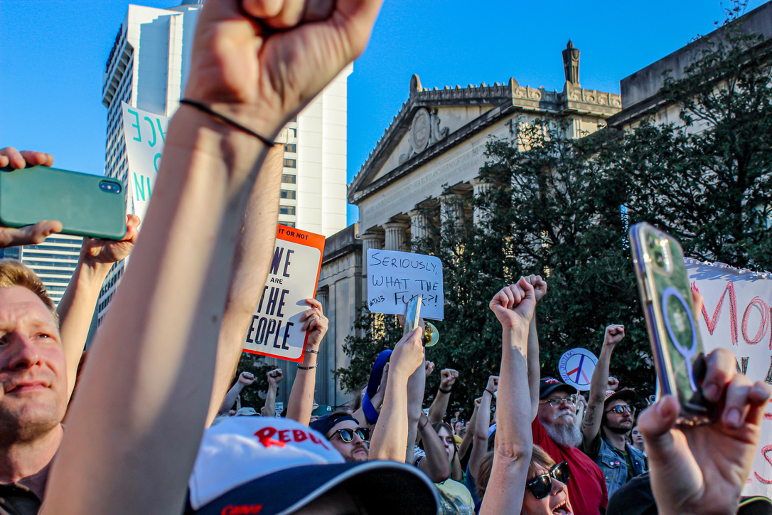 protesters hold up fists and signs in nashville